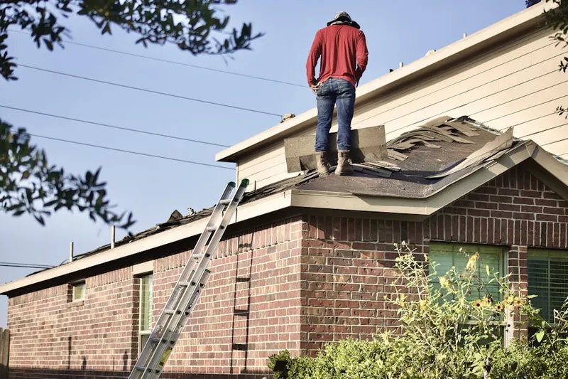 Professional roofer working on a residential roof in Red Cedar Hill